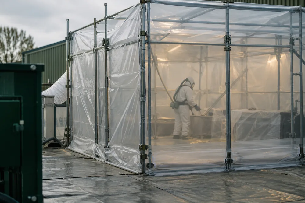 Controlled removal enclosure within an industrial work area